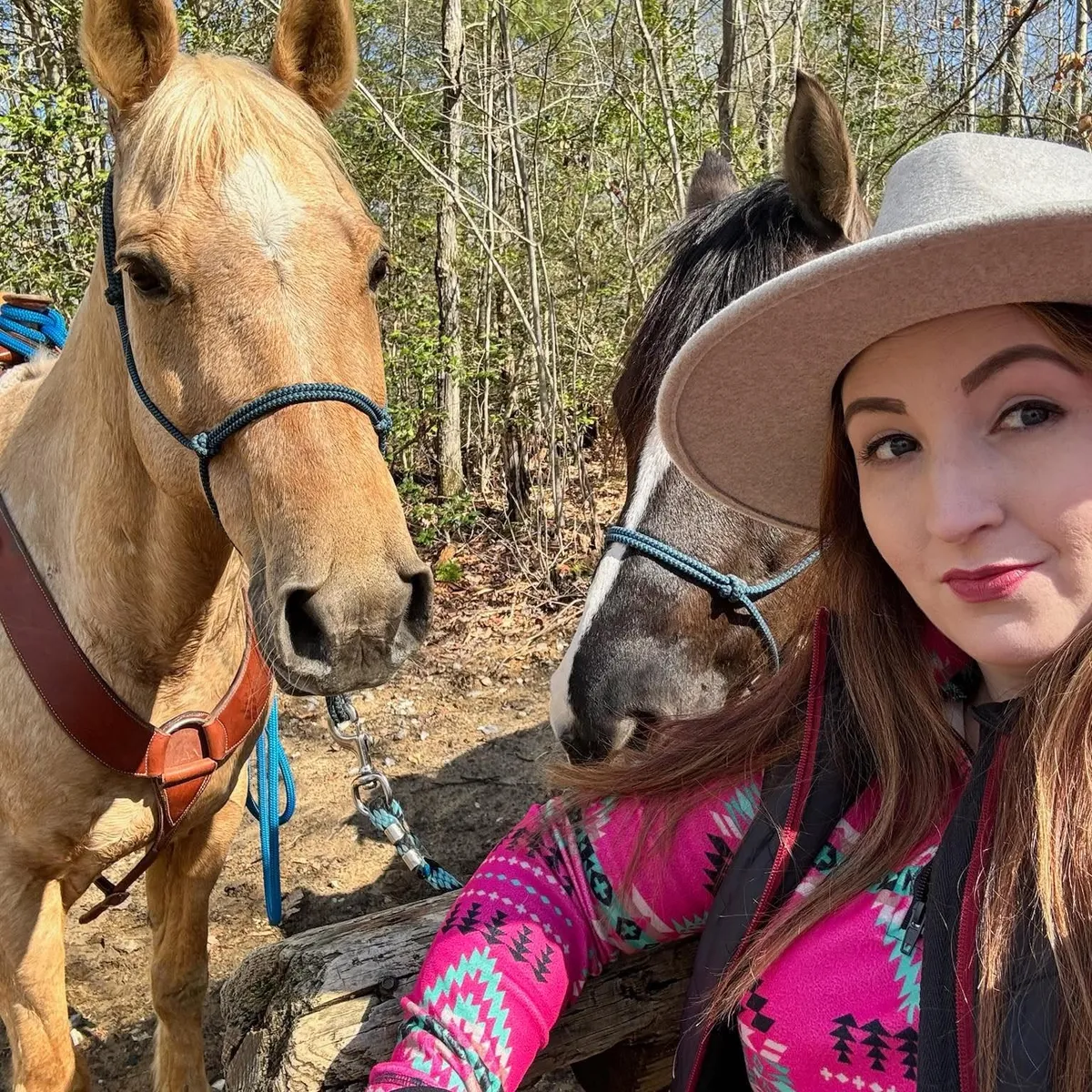 Brandi of Sun & Stone on a wooded trail ride with two horses